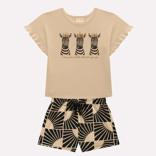 Children's outfit with beige top and patterned shorts on a white background